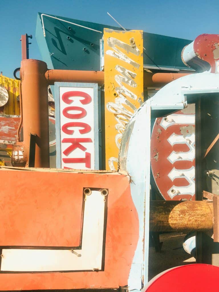 A collection of old signs in a deserted area, a must-see for your Las Vegas Bucket List.