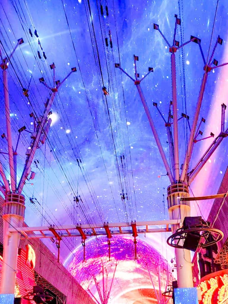 A breathtaking view of Las Vegas with wires and a planet in the background, making it a must-see on your Las Vegas Bucket List.