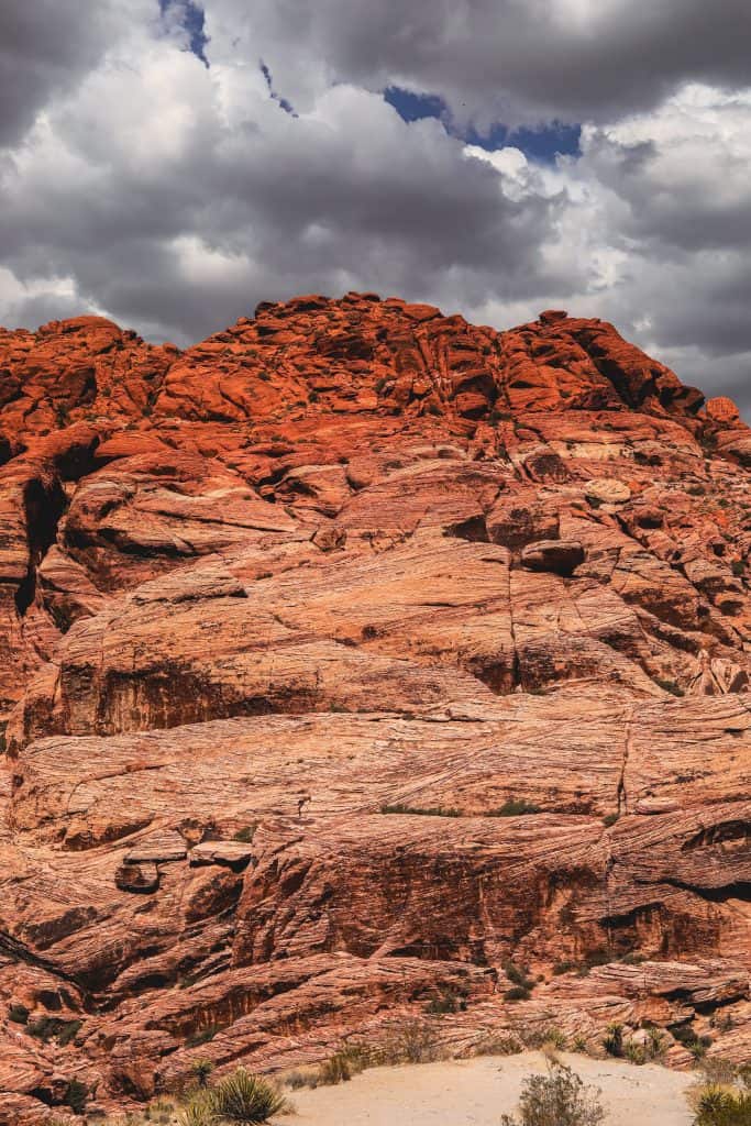 A red rock formation against a cloudy sky, evoking the experience of 4 days in Las Vegas.