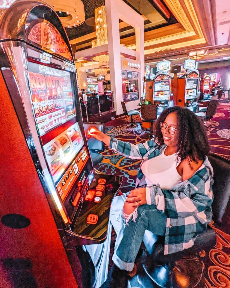 A woman sitting at a slot machine.