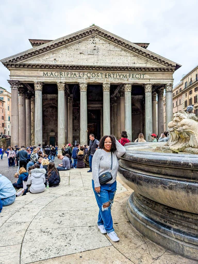 A woman standing in front of the pantheon in rome.