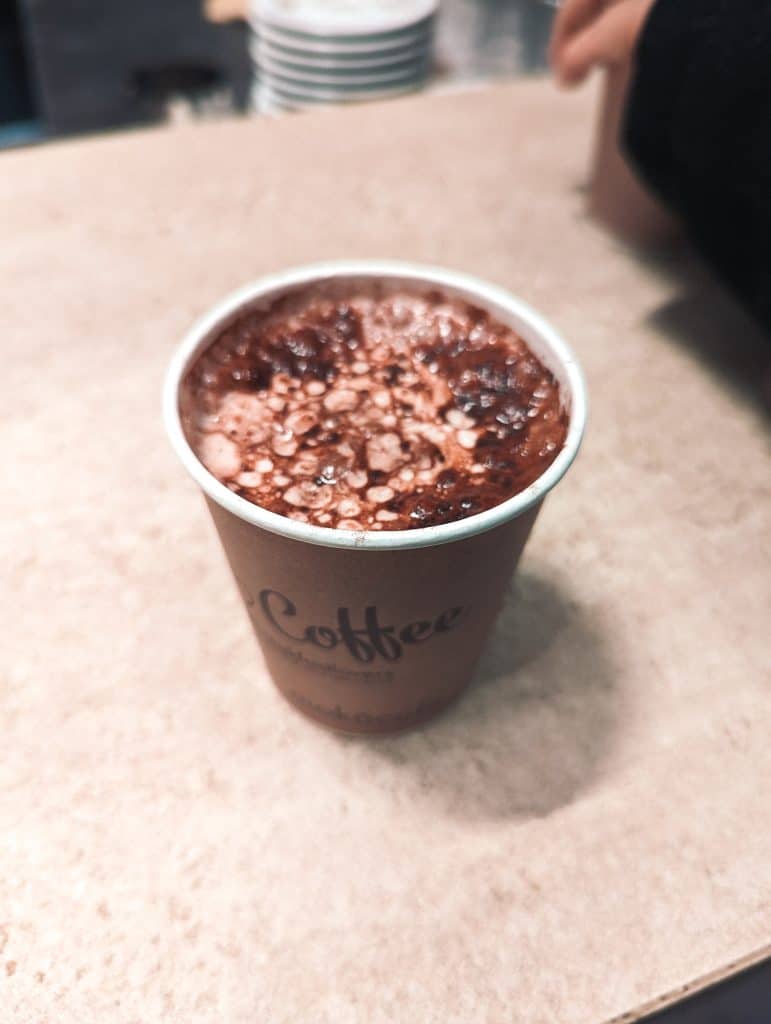 A cup of coffee sitting on top of a table.