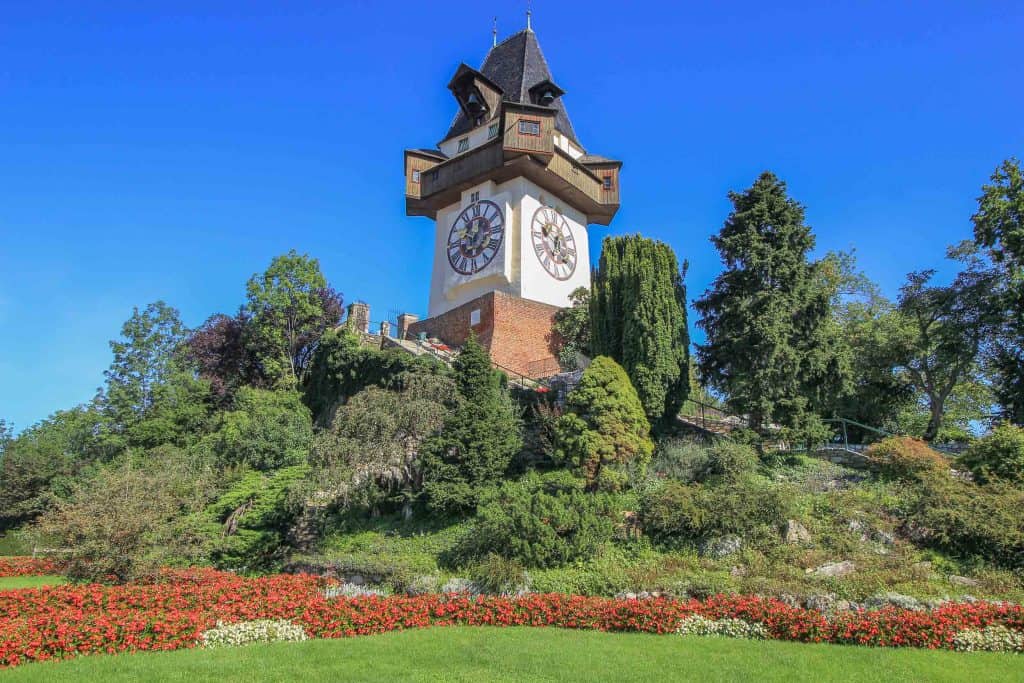 a clock tower that sits on top of a hill.