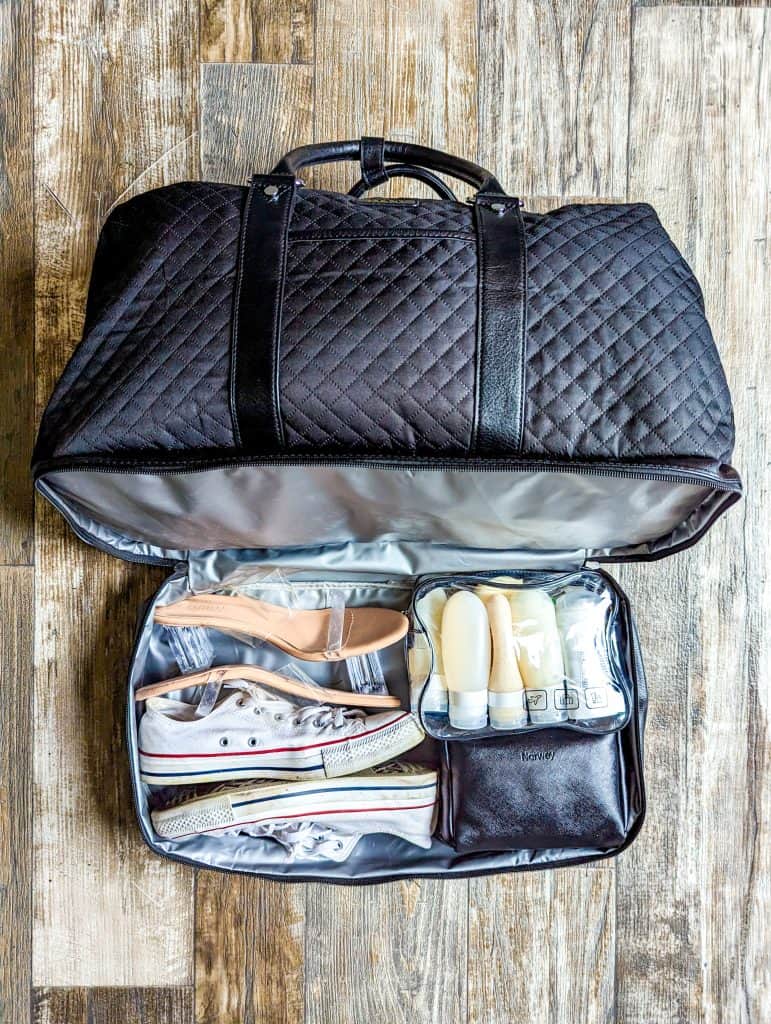 A black duffel bag filled with shoes and other items for Las Vegas.