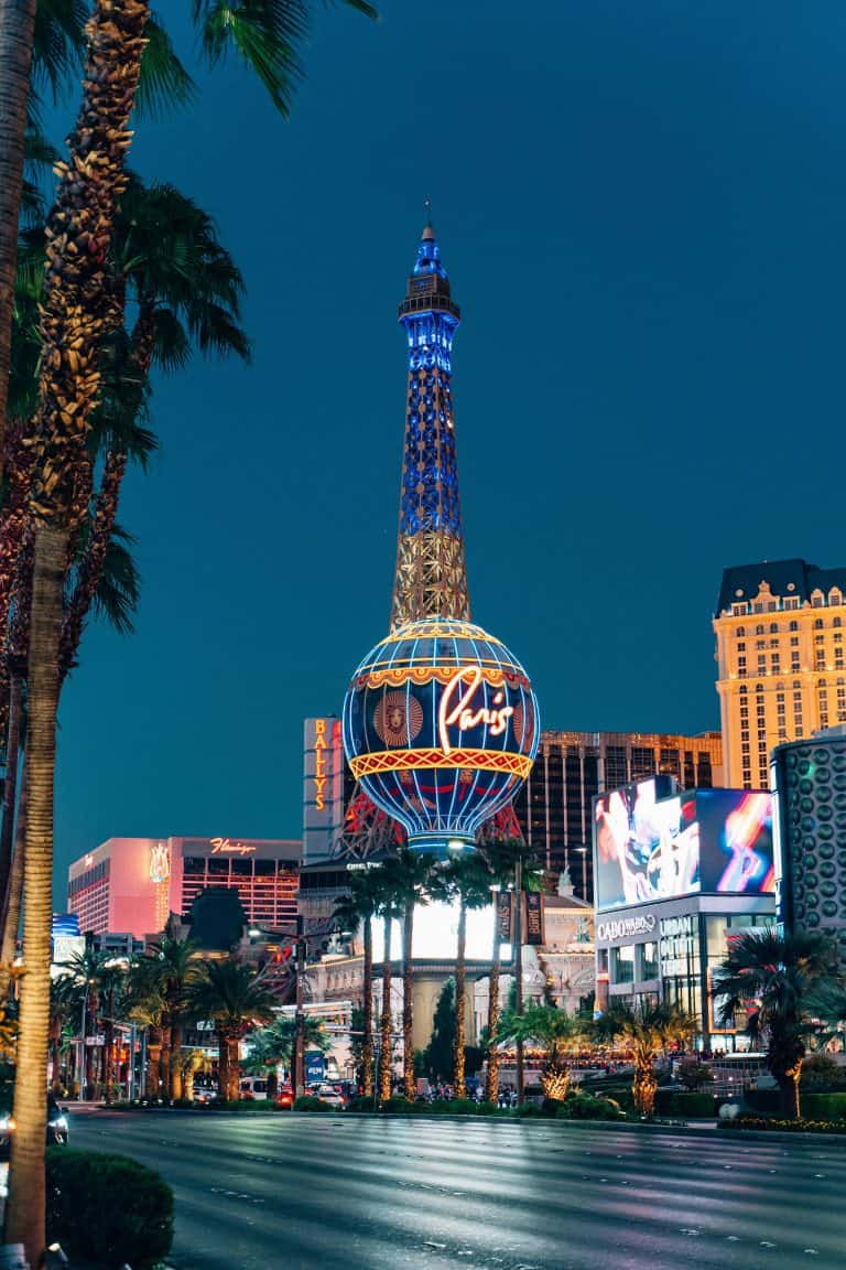 The Las Vegas Strip at night with a view of the Paris Las Vegas hotel featuring a replica of the Eiffel Tower is a must-add to your Nevada Bucket List.