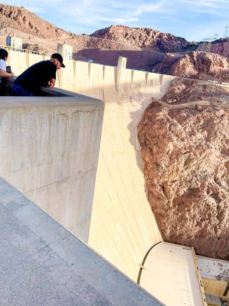 Person observing the hoover dam from a viewing platform.