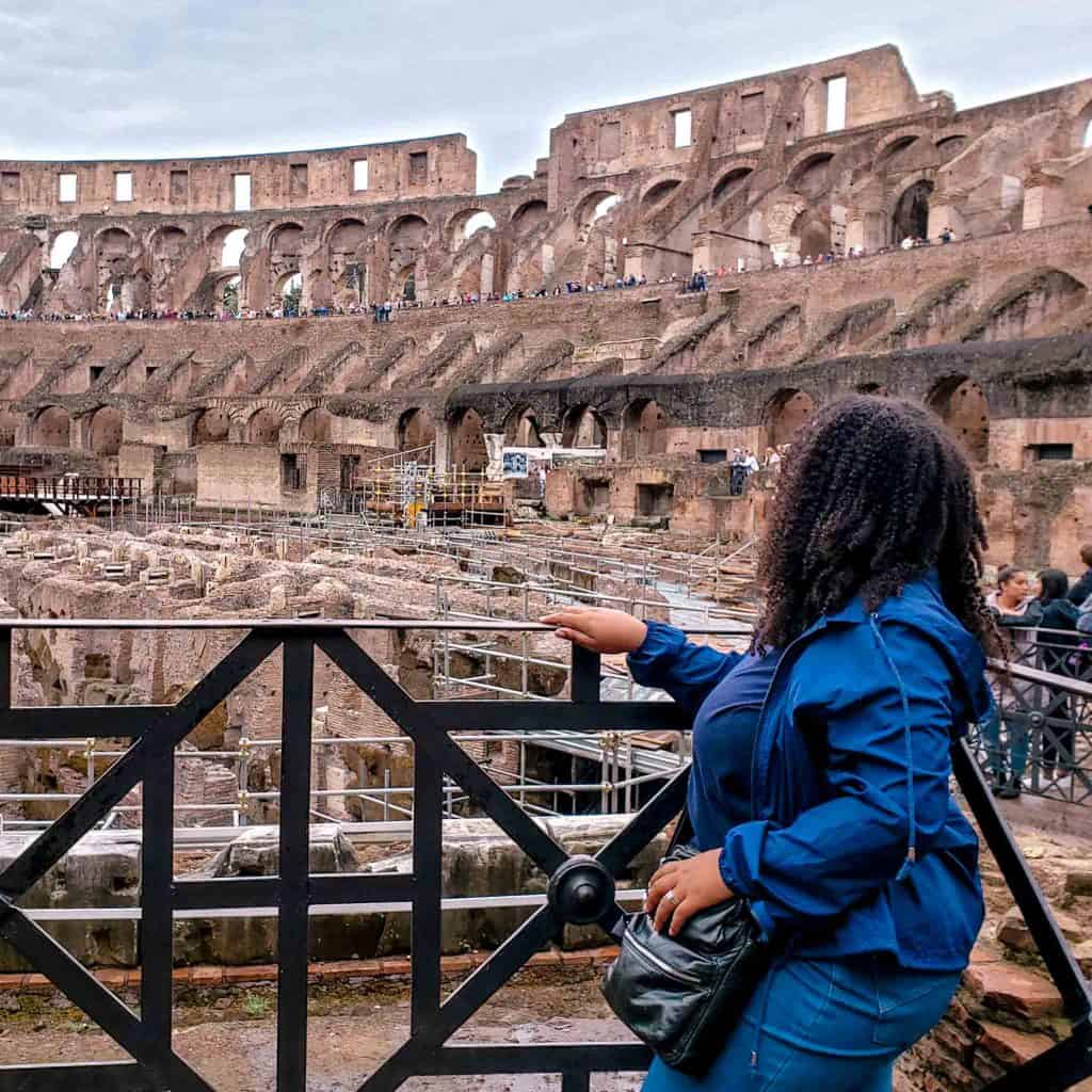 Woman touring the interior ruins of the colosseum in Rome, experiencing the best way to see the Colosseum.