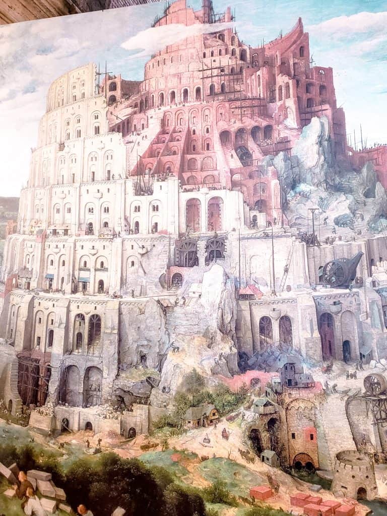 Depiction of the Tower of Babel as a vast, multi-tiered edifice under construction, with numerous arches and scaffolding, offering the best way to see the Colosseum.